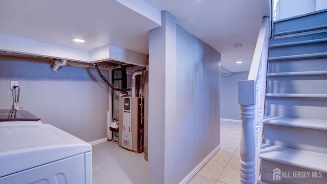 finished basement with baseboards, washer and dryer, light tile patterned floors, and recessed lighting