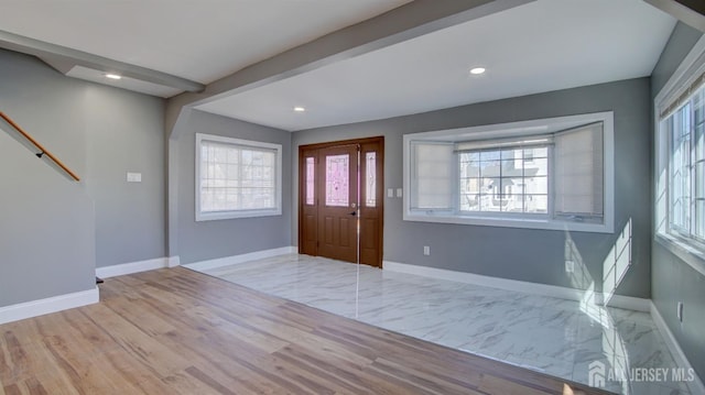 entryway with baseboards, light marble finish floors, and recessed lighting
