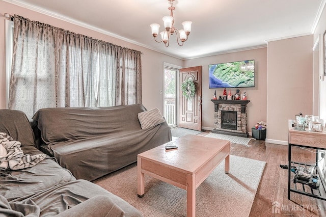 2 Bradley Dr, Edison, NJ 08817 - living room featuring a chandelier, ornamental molding, a stone fireplace, and wood finished floors