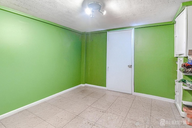 2 Bradley Dr, Edison, NJ 08817 - unfurnished bedroom featuring a textured ceiling and light tile patterned floors