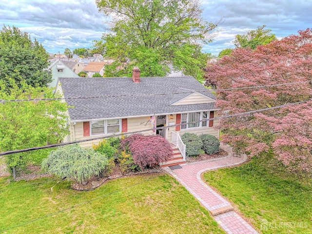 2 Bradley Dr, Edison, NJ 08817 - view of front of home featuring a shingled roof, a chimney, and a front yard