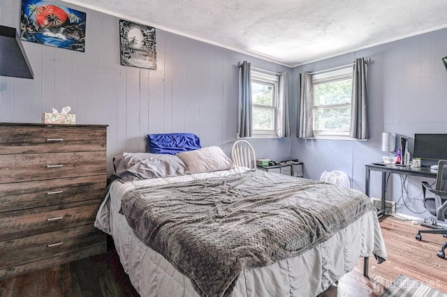 2 Bradley Dr, Edison, NJ 08817 - bedroom with wood finished floors, crown molding, a textured ceiling, wooden walls, and an office area