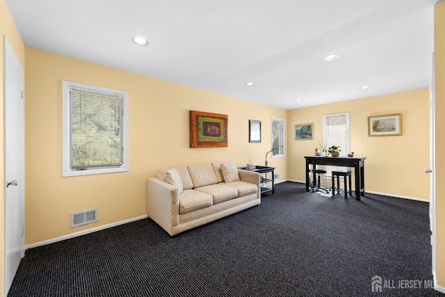 living room with dark colored carpet, baseboards, and recessed lighting
