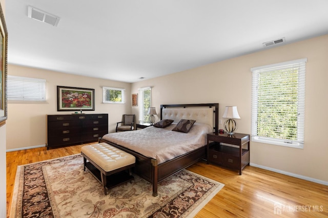 bedroom with wood finished floors and baseboards