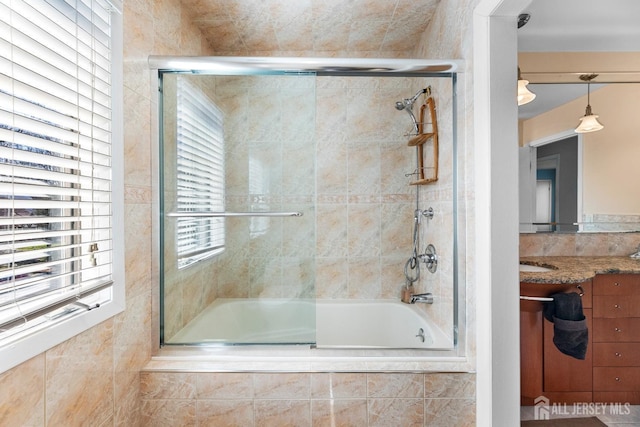 full bath with tiled shower / bath and vanity