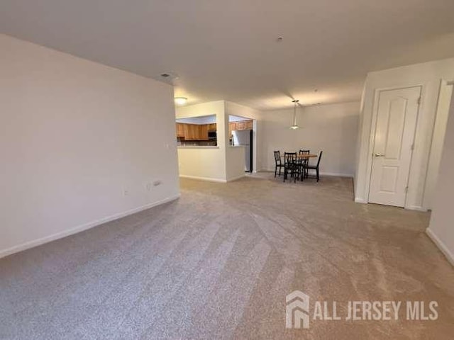 1027 Dogwood Ct, New Brunswick, NJ 08901 - carpeted living area with baseboards