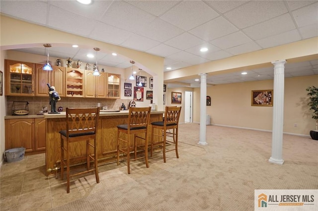 9 Lavender Way E, Brunswick, NJ 08816 - indoor wet bar featuring decorative columns, tasteful backsplash, decorative light fixtures, light colored carpet, and a paneled ceiling