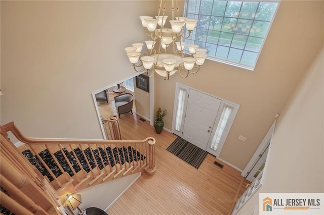 9 Lavender Way E, Brunswick, NJ 08816 - foyer entrance with a towering ceiling, a chandelier, light wood finished floors, and healthy amount of natural light