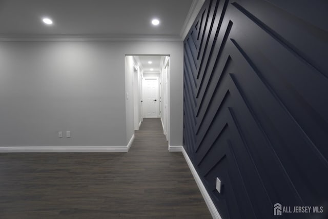 hall with ornamental molding and dark wood-type flooring