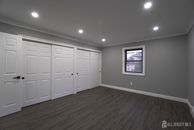 unfurnished bedroom with dark hardwood / wood-style flooring, a closet, and ornamental molding