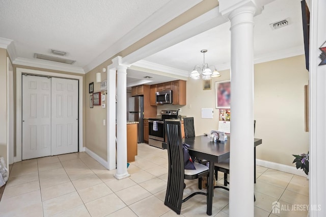 dining area featuring decorative columns, ornamental molding, light tile patterned floors, a notable chandelier, and a textured ceiling