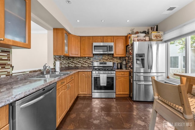 1058 Schmidt Ln, North Brunswick, NJ 08902 - kitchen with stainless steel appliances, backsplash, light stone countertops, glass insert cabinets, and dark tile patterned floors