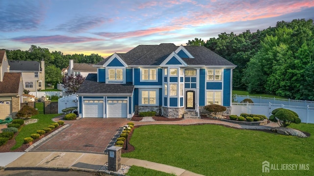 view of front of home featuring a yard and a garage