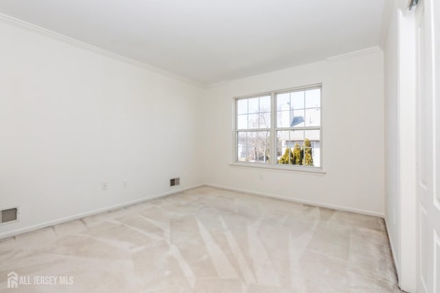 empty room with carpet flooring, baseboards, visible vents, and ornamental molding