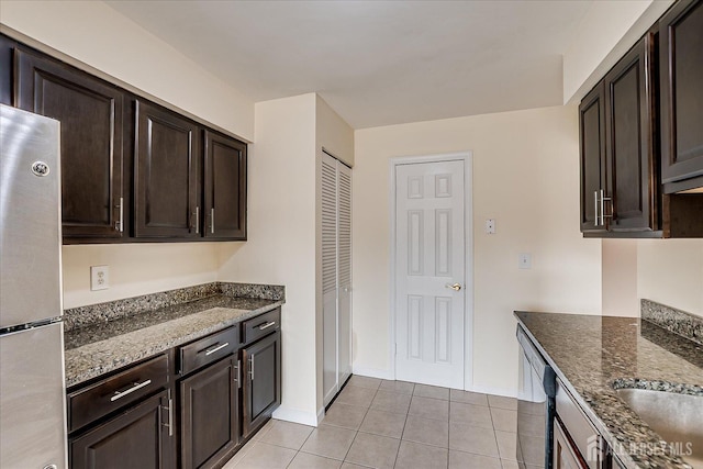223 Edison Glen Ter, Edison, NJ 08837 - kitchen with freestanding refrigerator, light tile patterned flooring, dishwasher, dark stone countertops, and dark brown cabinets