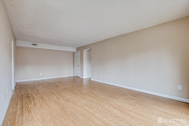 223 Edison Glen Ter, Edison, NJ 08837 - spare room featuring a textured ceiling and light wood-type flooring