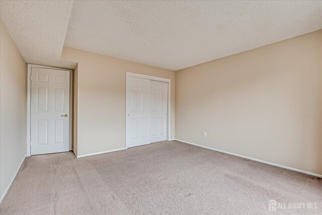 223 Edison Glen Ter, Edison, NJ 08837 - unfurnished bedroom featuring carpet, a closet, and a textured ceiling