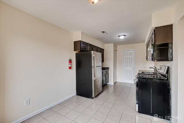 223 Edison Glen Ter, Edison, NJ 08837 - kitchen featuring appliances with stainless steel finishes, light tile patterned flooring, and dark brown cabinets