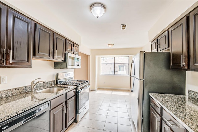 223 Edison Glen Ter, Edison, NJ 08837 - kitchen featuring stainless steel appliances, dark brown cabinets, light stone counters, and light tile patterned flooring