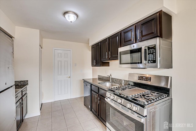 223 Edison Glen Ter, Edison, NJ 08837 - kitchen with appliances with stainless steel finishes, dark brown cabinets, light tile patterned floors, and dark stone countertops