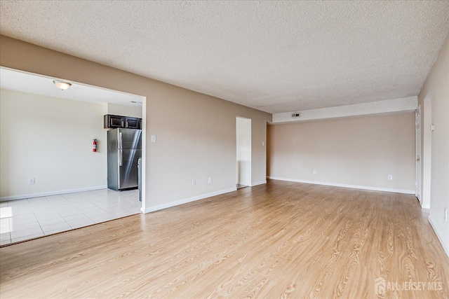 223 Edison Glen Ter, Edison, NJ 08837 - unfurnished room featuring light wood finished floors and a textured ceiling