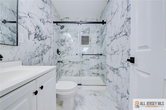 bathroom featuring a marble finish shower, vanity, toilet, tile walls, and marble finish floors
