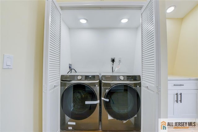 washroom with washing machine and clothes dryer and recessed lighting