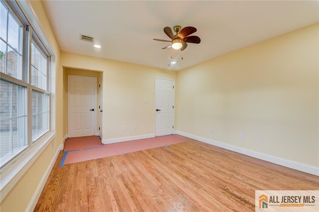 empty room with light wood-style floors, a ceiling fan, baseboards, and recessed lighting