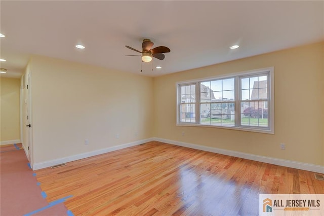 unfurnished room featuring a ceiling fan, wood finished floors, baseboards, and recessed lighting
