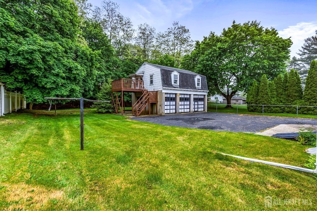 125 Deerfield Rd, Sayreville, NJ 08872 - view of front of house with a gambrel roof, a wooden deck, stairs, a garage, and driveway