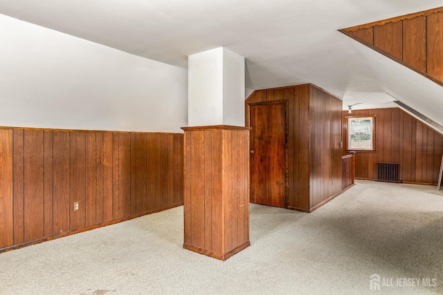 125 Deerfield Rd, Sayreville, NJ 08872 - bonus room featuring vaulted ceiling, radiator heating unit, wooden walls, and light colored carpet