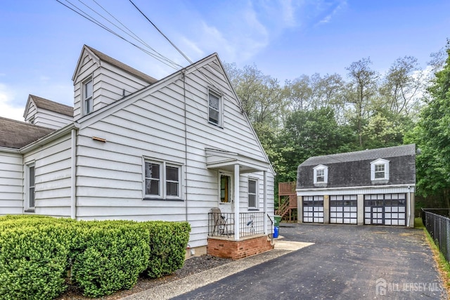 125 Deerfield Rd, Sayreville, NJ 08872 - view of front facade with a detached garage, an outbuilding, and a shingled roof