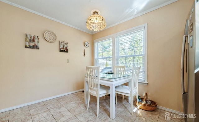 dining room featuring crown molding, baseboards, and a chandelier