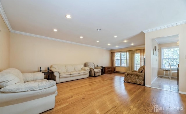 living area with ornamental molding, light wood-type flooring, baseboards, and recessed lighting