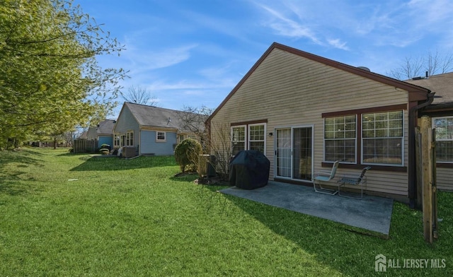 back of property with a patio, a yard, and cooling unit