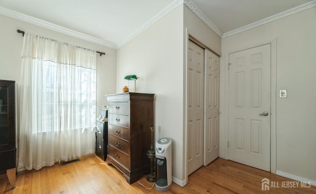 interior space with ornamental molding and light wood finished floors