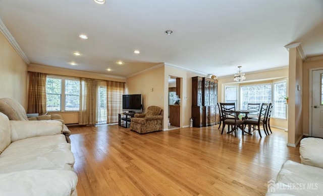 living area featuring ornamental molding, light wood-style flooring, a chandelier, recessed lighting, and baseboards