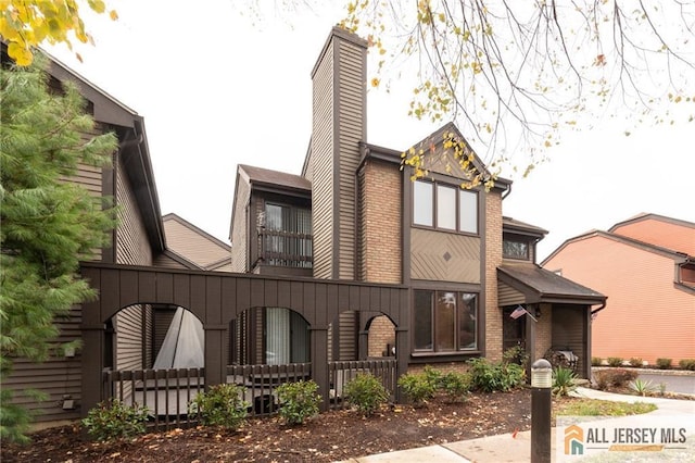 96 Riverbend Dr, North Brunswick, NJ 08902 - rear view of house with a chimney