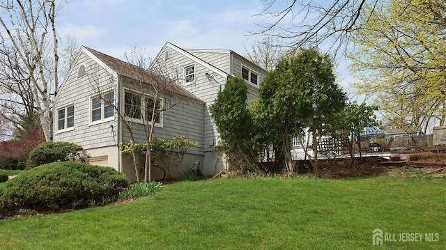 view of side of property featuring a yard