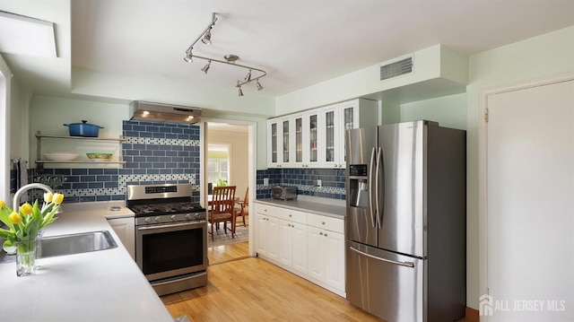 kitchen with open shelves, white cabinets, appliances with stainless steel finishes, visible vents, and under cabinet range hood