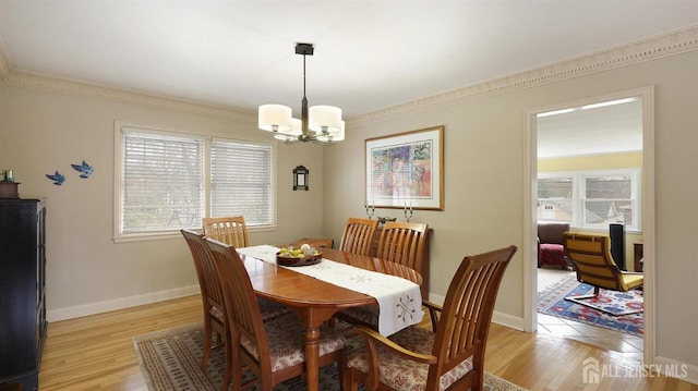 dining room featuring a chandelier, plenty of natural light, and light wood finished floors