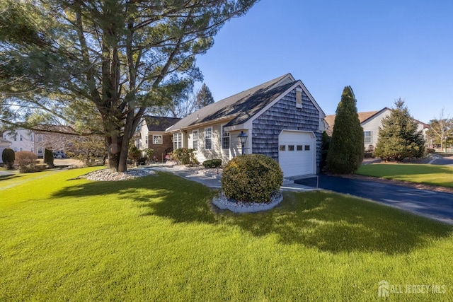 view of side of property featuring a garage and a lawn