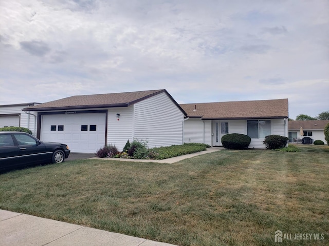 17 Celtis Plz Unit B, Monroe, NJ 08831 - view of home's exterior with an attached garage, a yard, roof with shingles, and concrete driveway