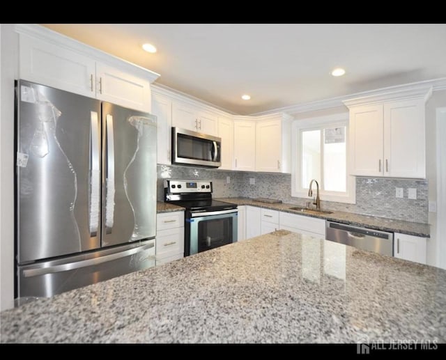 17 Celtis Plz Unit B, Monroe, NJ 08831 - kitchen featuring appliances with stainless steel finishes, white cabinetry, light stone counters, and recessed lighting