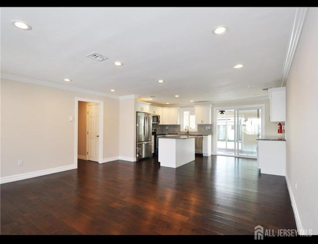 17 Celtis Plz Unit B, Monroe, NJ 08831 - unfurnished living room with ornamental molding, recessed lighting, and dark wood finished floors