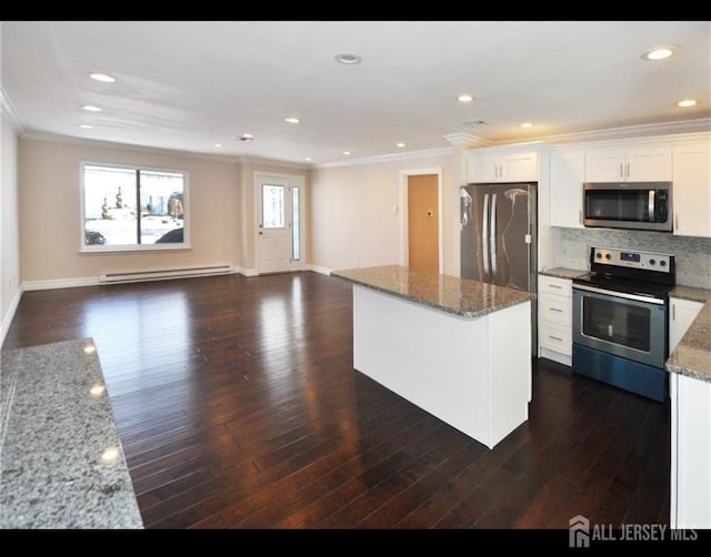 17 Celtis Plz Unit B, Monroe, NJ 08831 - kitchen featuring appliances with stainless steel finishes, a baseboard heating unit, crown molding, dark wood finished floors, and a kitchen island