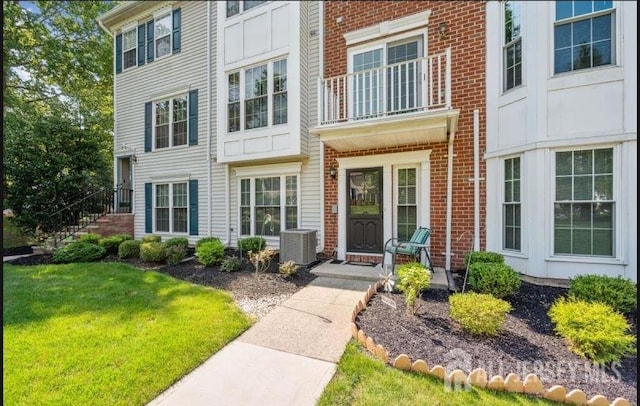 4108 Dilts Ln, Bridgewater, NJ 08807 - view of exterior entry with brick siding and a lawn