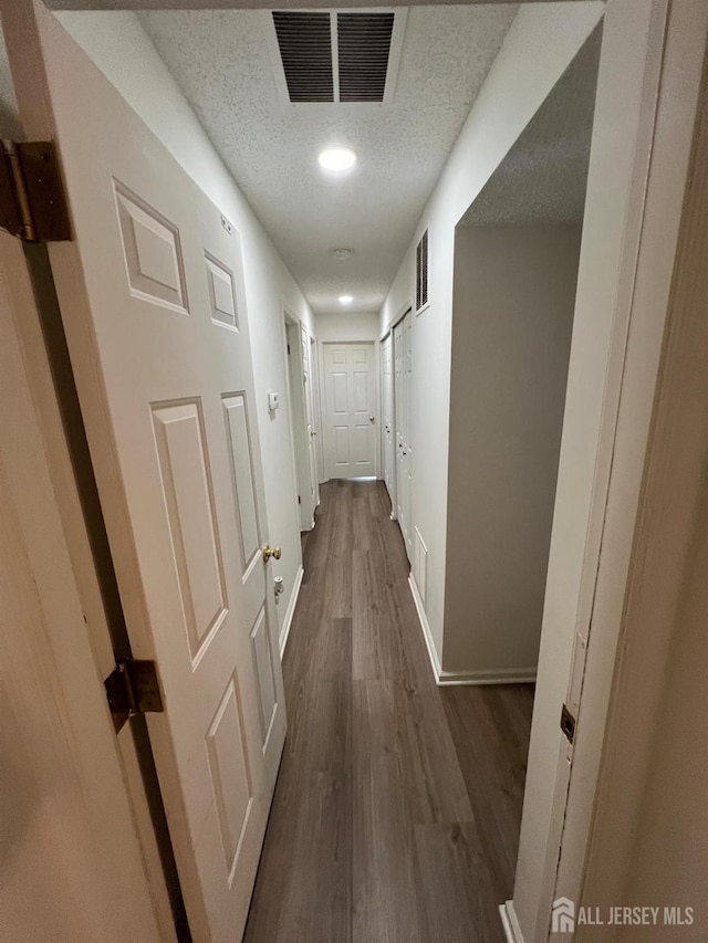4108 Dilts Ln, Bridgewater, NJ 08807 - hallway featuring dark wood-type flooring, a textured ceiling, and recessed lighting