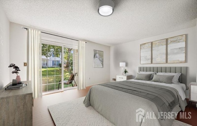 4108 Dilts Ln, Bridgewater, NJ 08807 - bedroom featuring access to outside, a textured ceiling, and wood finished floors