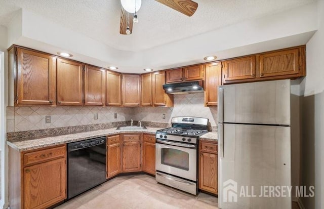 4108 Dilts Ln, Bridgewater, NJ 08807 - kitchen with appliances with stainless steel finishes, under cabinet range hood, brown cabinetry, backsplash, and ceiling fan